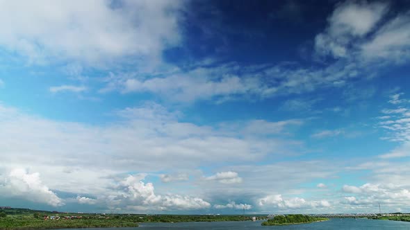 Oncoming White Cumulus Clouds Over Scenic Landscape