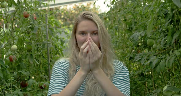 Girl Farmer Shows Tomatoes in Her Hands to the Camera