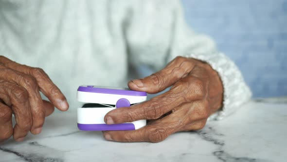 Senior Young Women Hand Using Pulse Oximeter