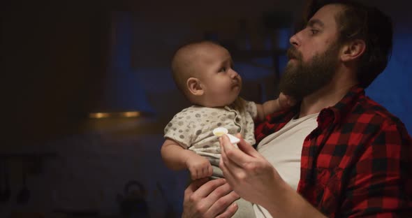 Father Feeding a Baby at Night