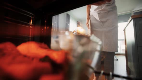 Woman Cooking Food in Oven at Home Kitchen