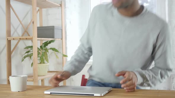 AfroAmerican Man Coming and Starts Work on Laptop