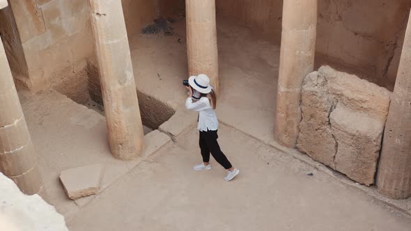 Female Archeologist Taking Pictures of Ancient Buildings