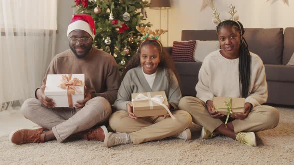 Portrait of Happy African-American Family with Christmas Presents