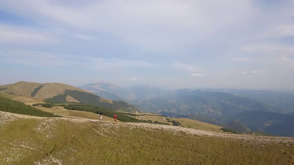 Drone view of two friends hiking in the Apennines, Umbria, Italy