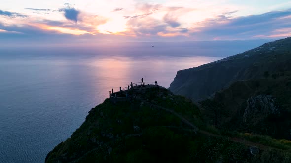 Travellers at Raposeira observation deck, Madeira sunset view; aerial