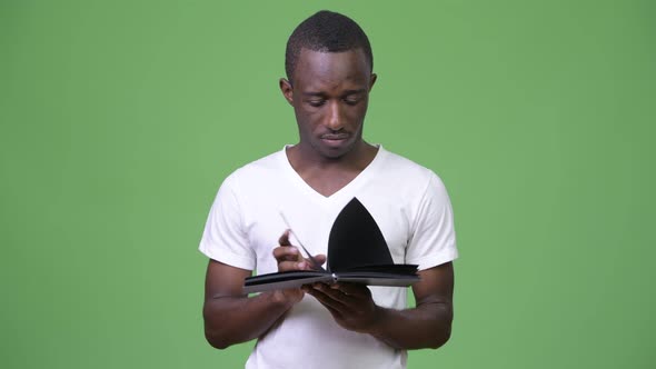 Young African Man Reading Book