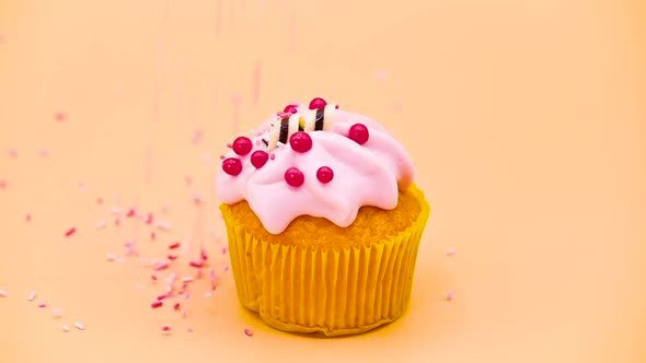 Delicious Cupcake with Sprinkles Falling in Slow Motion