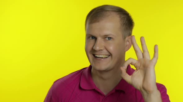 Portrait of Caucasian Man Posing in T-shirt. Smiling Handsome Guy Show OK Sign. People Emotions