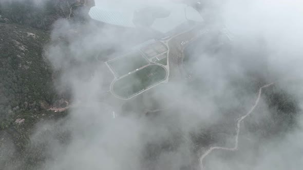 Over the city in the clouds aerial view 4 K