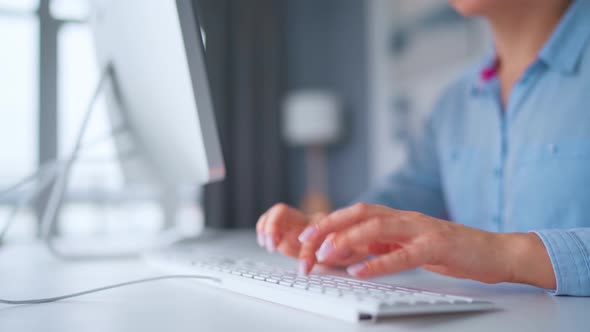 Woman in Glasses Typing on a Computer Keyboard. Concept of Remote Work.