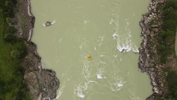 Tourists Raft Along the River on an Inflatable Boat