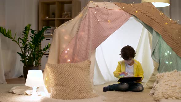 Little Boy with Tablet Pc in Kids Tent at Home