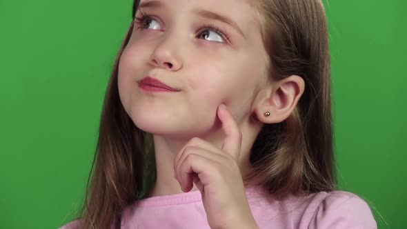 Baby Is Looking at the Side, She Is Thoughtful. Green Screen. Close Up. Slow Motion