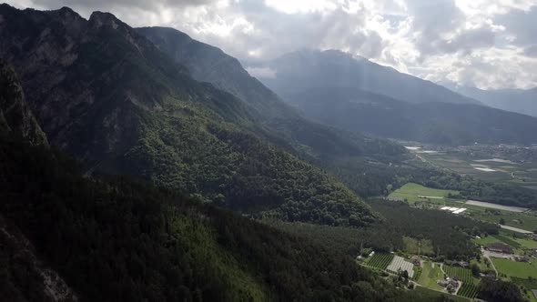 Aerial reveal type shot of the mountains and forest in Borgo Valsugana in Trentino Italy