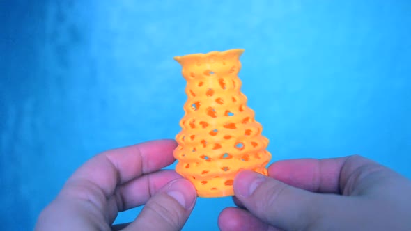 The Person Holds on His Hands and View Yellow Object Created on 3d Printer