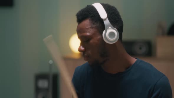 Black Guy Playing Drums in Evening