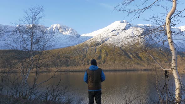 A Man, a Middle-aged Athlete, Meets the Dawn in the Mountains