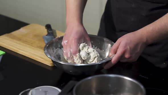 A cook preparing dough