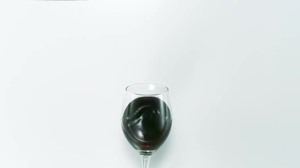 Red wine splashing out of glass, Slow Motion
