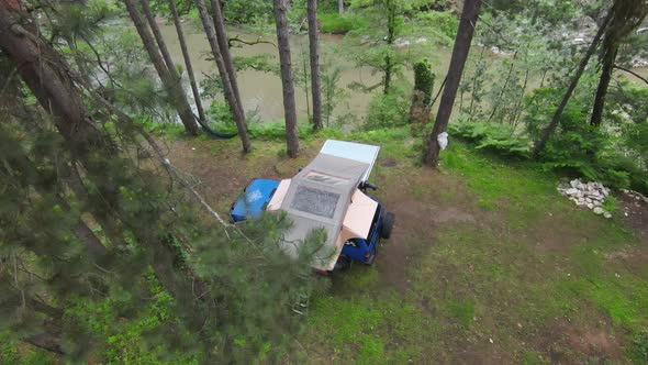 Top View of a Car Roof Toptent for Camping on the Roof Rack of an Offroad Car in a Forest on a Misty