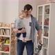 Young father holding his baby son while doing house cleanup - VideoHive Item for Sale