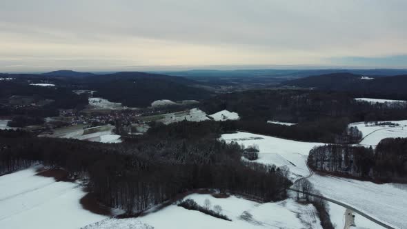 Flying above a wind turbine. Wind power plant in a winter landscape.