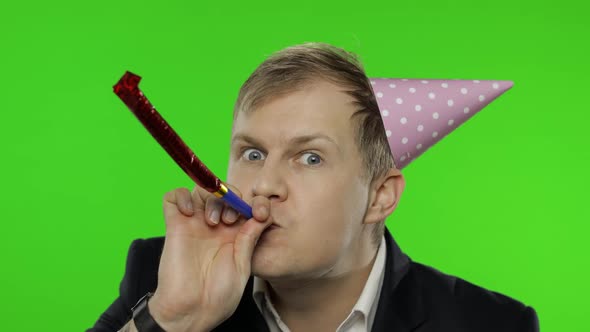 Drunk Disheveled Young Businessman in Festive Cap Celebrates and Dances