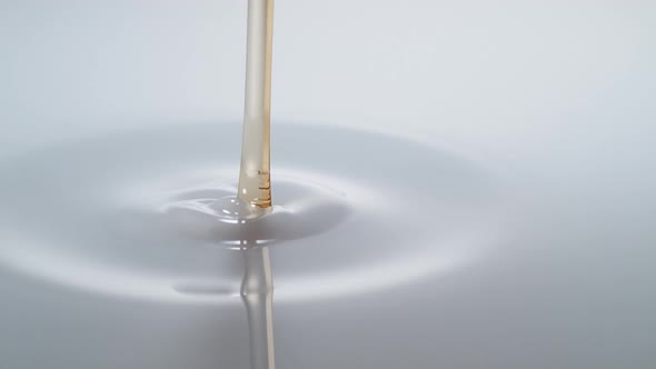 Pouring oil into milk and making splash. Slow Motion. alt