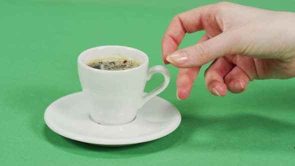 Female hand taking the coffee cup