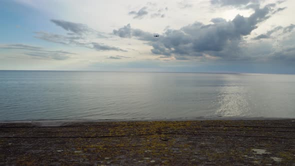 Landscape of Coastline with Sea at a Summer Day and Flying Drone Over It