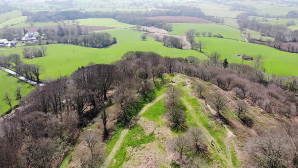 Aerial forward view looking over the Iron Age Fort of Hembury in Devon England on a sunny day