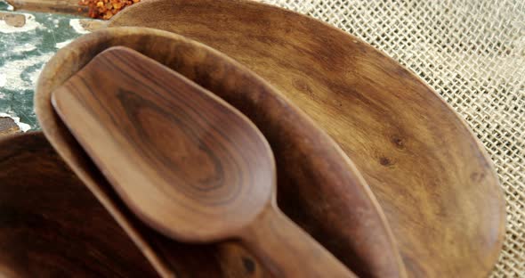 Empty wooden bowl with crushed red pepper on sack 4k