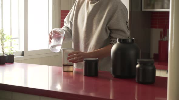 Shaking A Portion Of Protein Powder Into The Shaker bottle