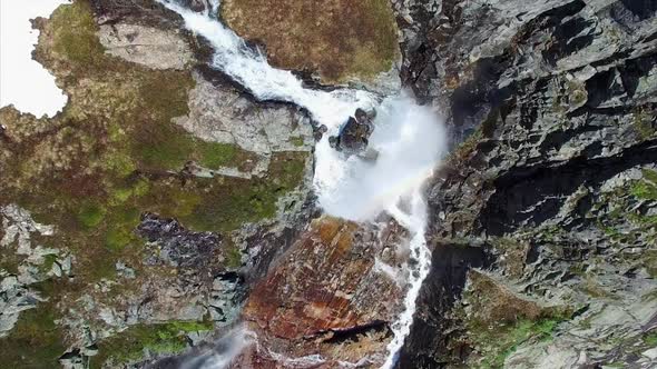 Aerial top-down footage of picturesque tall waterfall in Norway, aerial footage