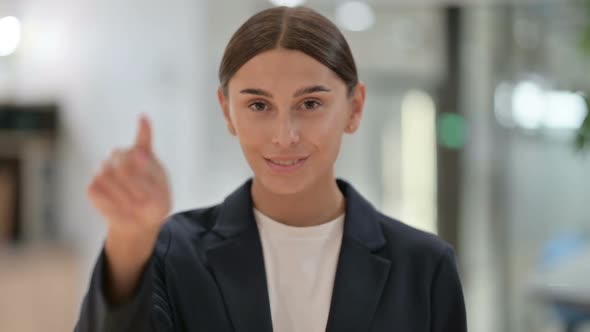 Portrait of Invitng Businesswoman Pointing with Finger