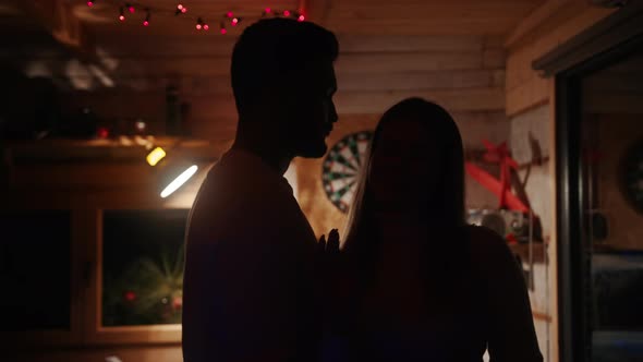 Happy Young Couple Flirting and Dancing at Birthday Party