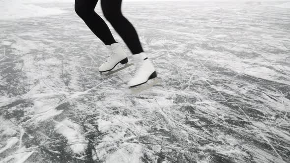 Beautiful figure ice skating on frozen lake