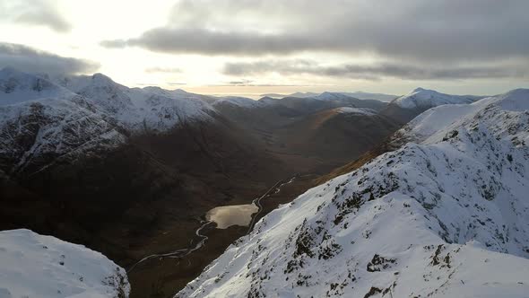 Mountaineer on the Summit of a Snowy Mountain