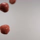 Whole and half sliced strawberries flying through in front of the camera - VideoHive Item for Sale