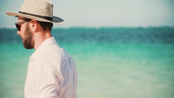 Happy Businessman Enjoying Tropical  Resort Hotel. Handsome Man Walking On Tropical Beach.