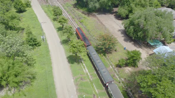 Aerial view of Thai local old classic train on railway on River Kwai Bridge