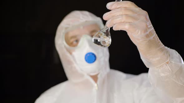 Chemical Worker in Protective Costume Looking Clean Water in Lab Tube Isolated on White Background