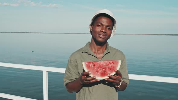 Guy Holding Piece of Watermelon