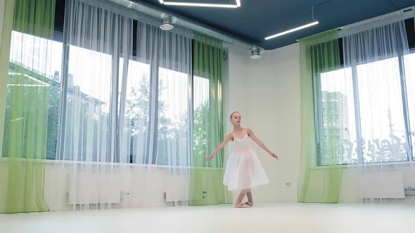 Girl in Skirt Dances Classical Ballet in Studio