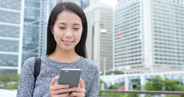 Young woman use of smart phone in city