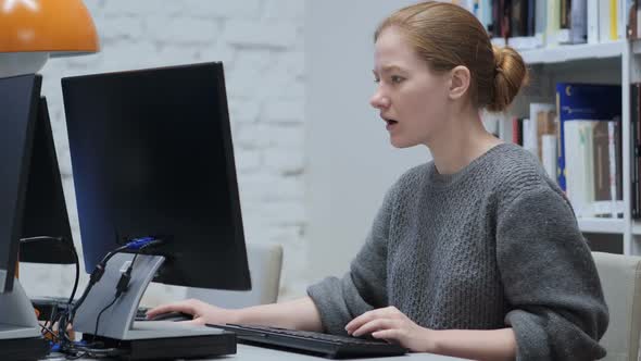 Redhead Woman Upset By Loss Working on Laptop