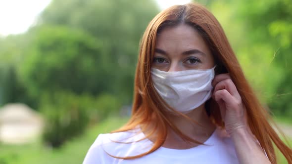 The girl takes off her medical mask