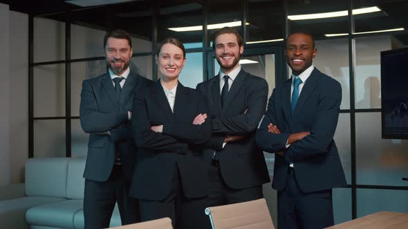 Smiling people in a suit in the office. Business people looking at camera