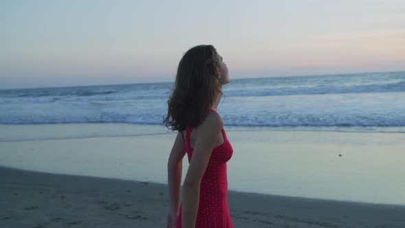 Girl admiring the ocean at sunset